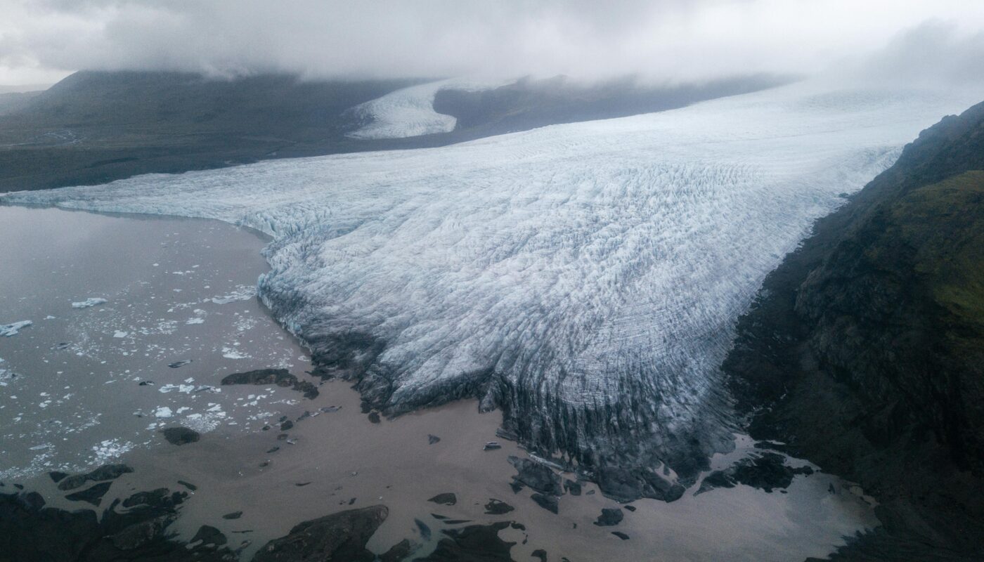 https://www.pexels.com/photo/majestic-glacier-tongue-reaching-seashore-under-gloomy-misty-sky-4338103/