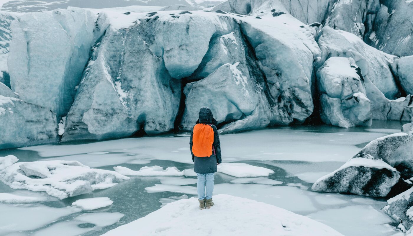 https://www.pexels.com/photo/person-standing-on-ice-near-glacier-5111047/