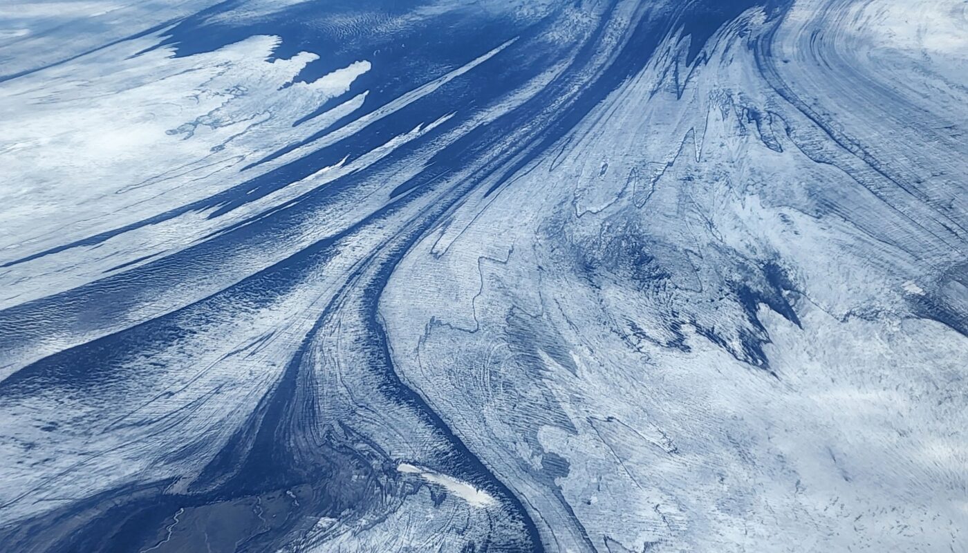 https://www.pexels.com/photo/birds-eye-view-of-a-mountain-landscape-covered-in-snow-12993599/