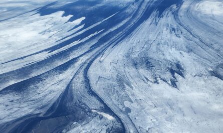 https://www.pexels.com/photo/birds-eye-view-of-a-mountain-landscape-covered-in-snow-12993599/