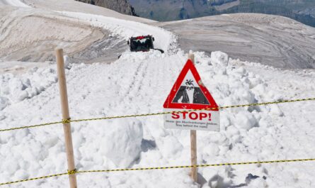 https://www.pexels.com/photo/snow-covered-mountain-road-with-warning-sign-35471250/