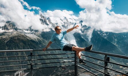 https://www.pexels.com/photo/man-sitting-on-railing-and-posing-against-glacier-in-france-alps-18261748/